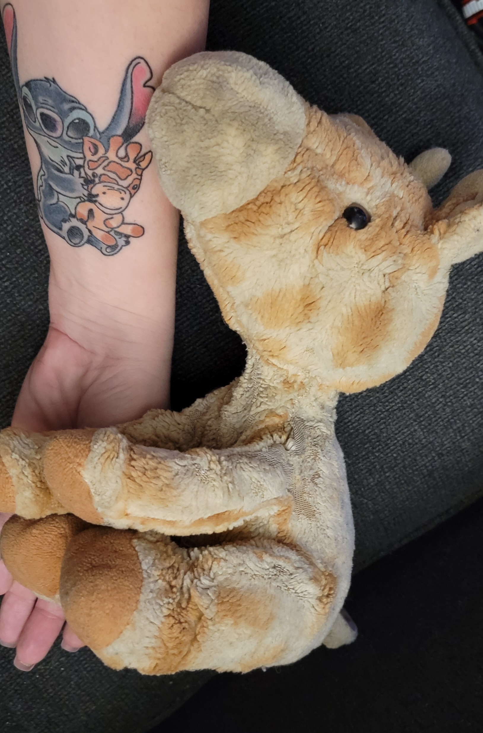 Tattoo on arm sitting by giraffe